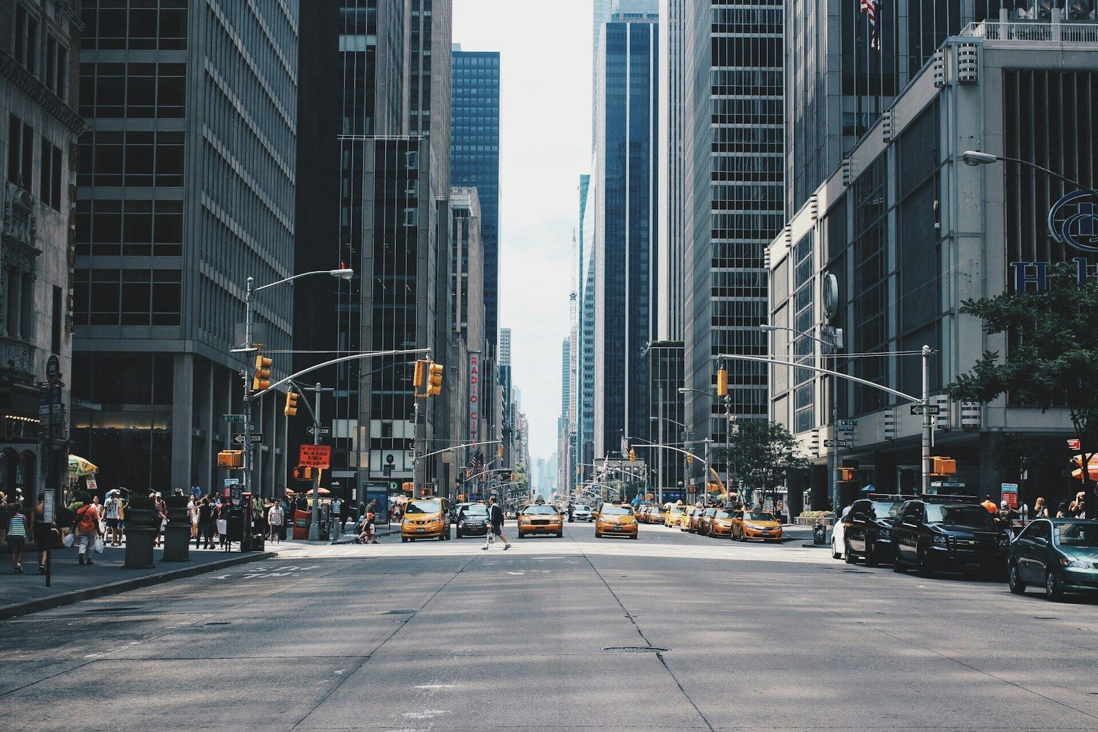 A wide city street with traffic lights and cars