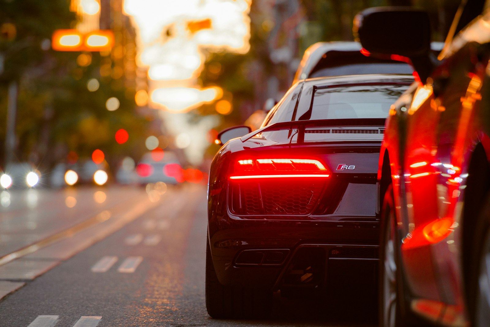 A car driving through a city street at sunset